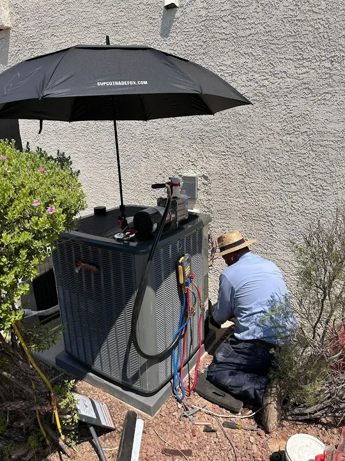 HVAC technician performing outdoor AC maintenance in Josephine
